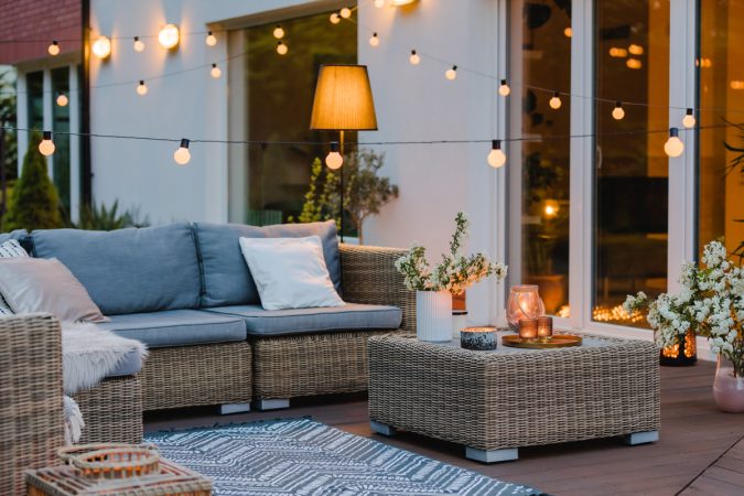 Summer evening on the terrace of beautiful suburban house with p